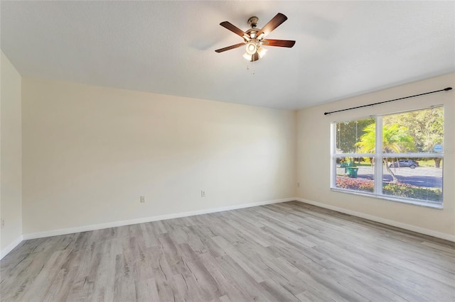 empty room with light wood-style floors, baseboards, and a ceiling fan