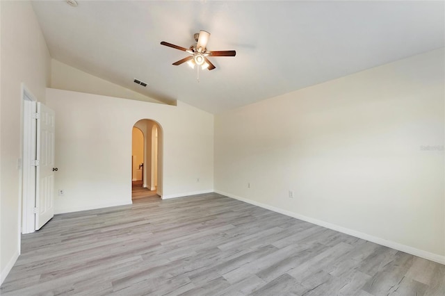 empty room featuring light hardwood / wood-style flooring, ceiling fan, and vaulted ceiling