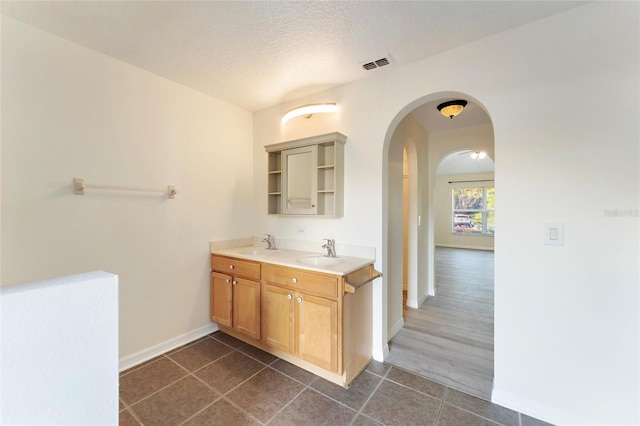 bathroom featuring vanity, a textured ceiling, and wood-type flooring