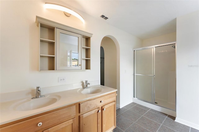 bathroom with vanity, tile patterned floors, and walk in shower