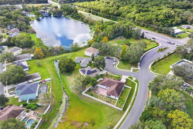 birds eye view of property featuring a wooded view, a water view, and a residential view