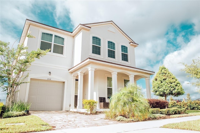 view of front of home featuring a porch and a garage