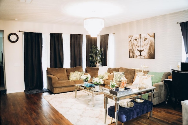 living room featuring a chandelier and dark hardwood / wood-style flooring