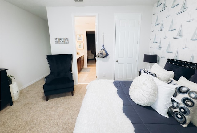 carpeted bedroom featuring ensuite bathroom