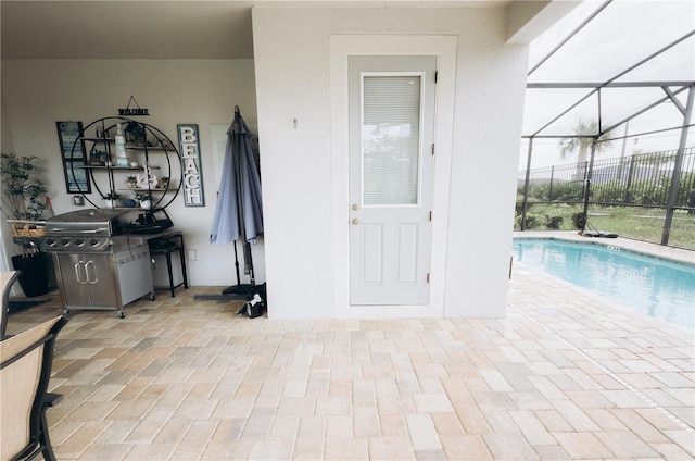 view of swimming pool featuring a patio and glass enclosure