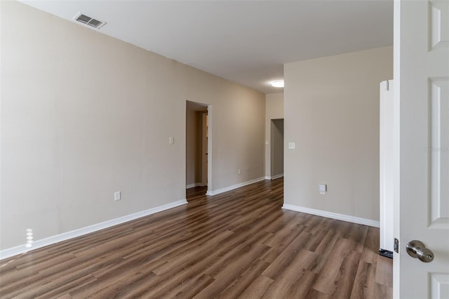 unfurnished room with dark wood-type flooring