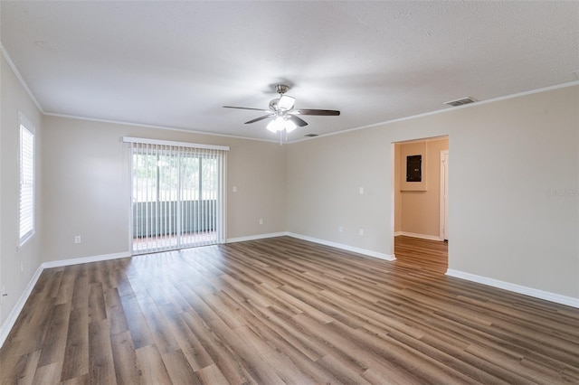 empty room with ceiling fan, wood-type flooring, a textured ceiling, and crown molding