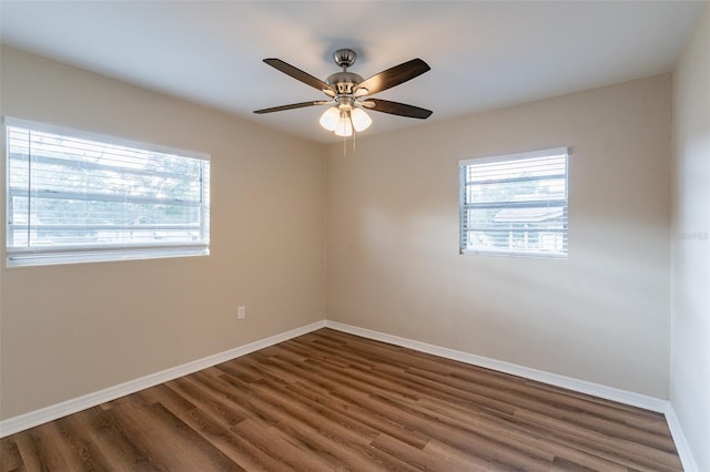 unfurnished room with dark wood-type flooring and ceiling fan