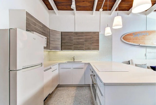 kitchen with wooden ceiling, sink, pendant lighting, white refrigerator, and white cabinetry