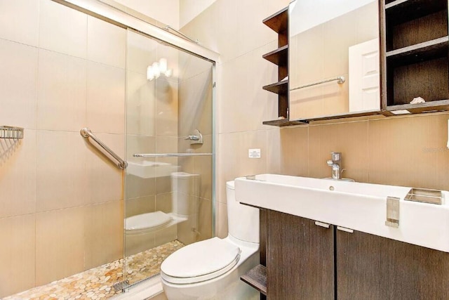 bathroom with vanity, toilet, walk in shower, and tile walls