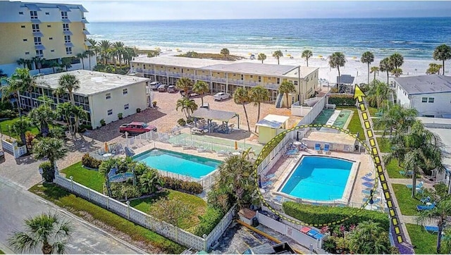 drone / aerial view with a water view and a view of the beach