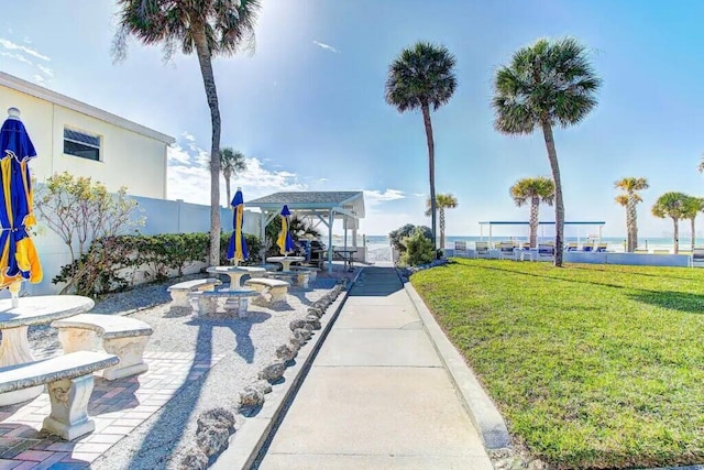 view of home's community with a patio and a yard