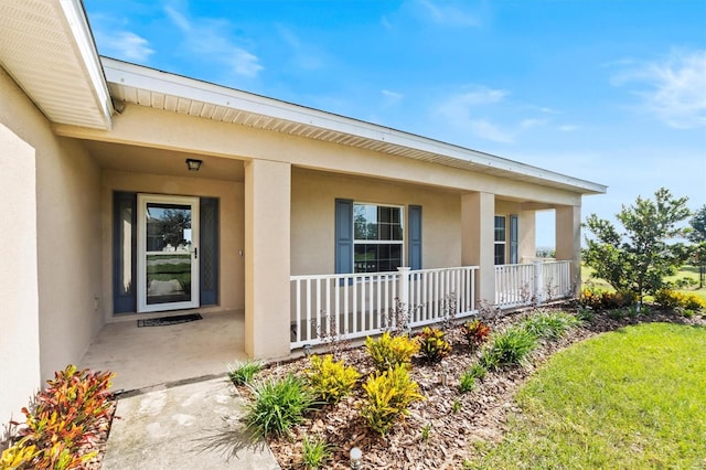 entrance to property featuring covered porch