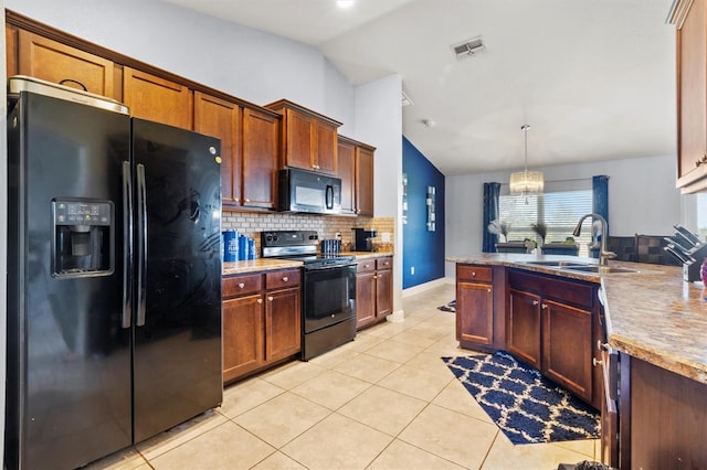 kitchen featuring black appliances, sink, lofted ceiling, decorative light fixtures, and light tile patterned floors