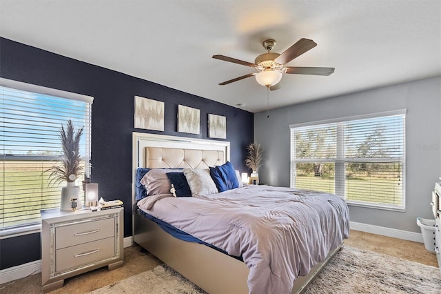 bedroom featuring light colored carpet and ceiling fan