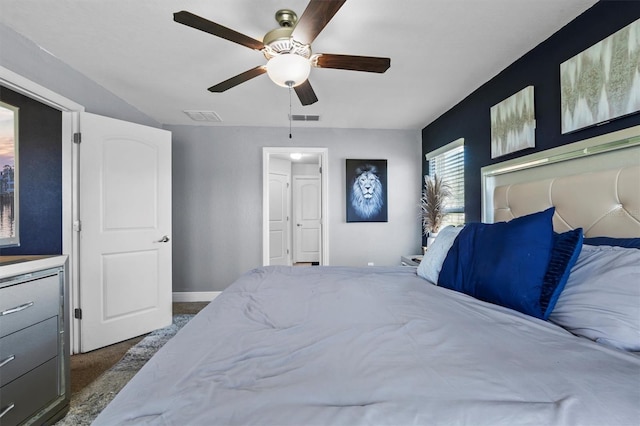 bedroom featuring ceiling fan and dark carpet