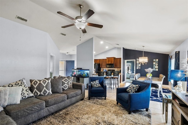 tiled living room with vaulted ceiling and ceiling fan with notable chandelier