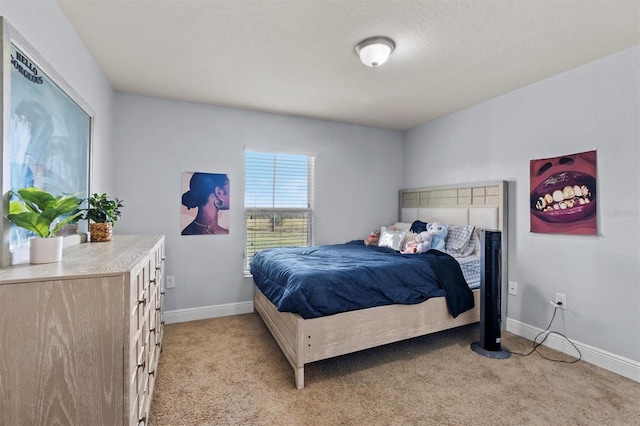 bedroom with light carpet and a textured ceiling