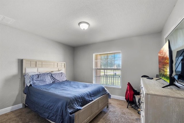 carpeted bedroom with a textured ceiling