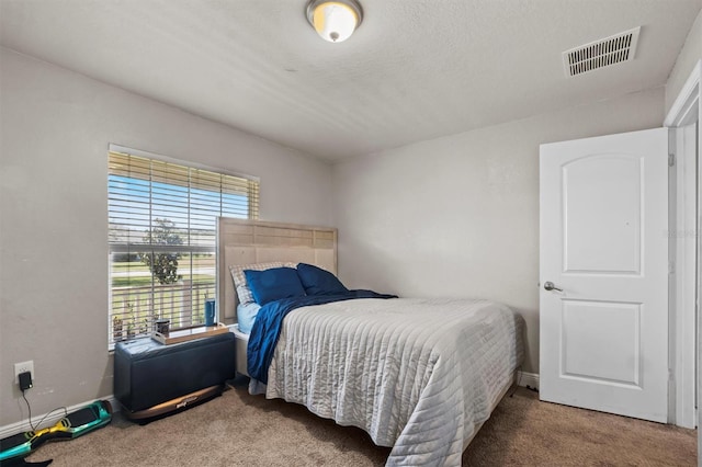 bedroom with a textured ceiling and carpet floors