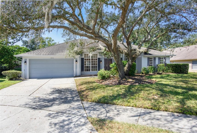 ranch-style house featuring a front lawn and a garage