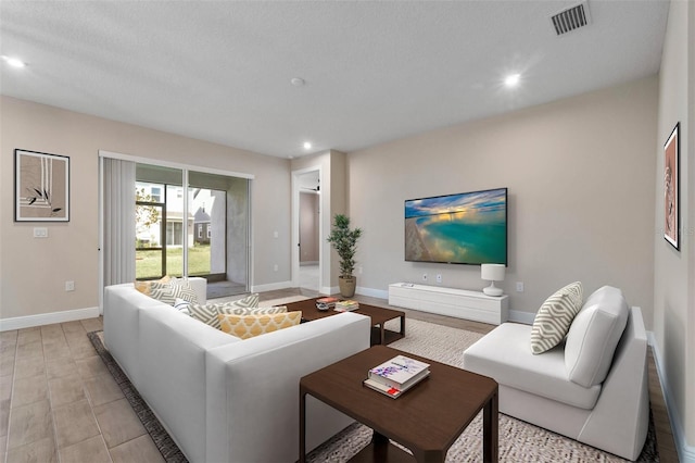 living room with a textured ceiling