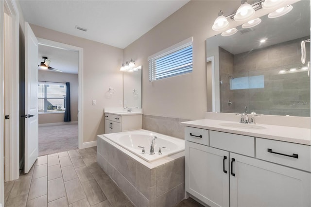 bathroom featuring vanity, ceiling fan, and independent shower and bath