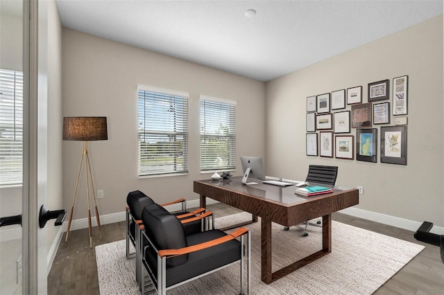 office area featuring baseboards and wood finished floors