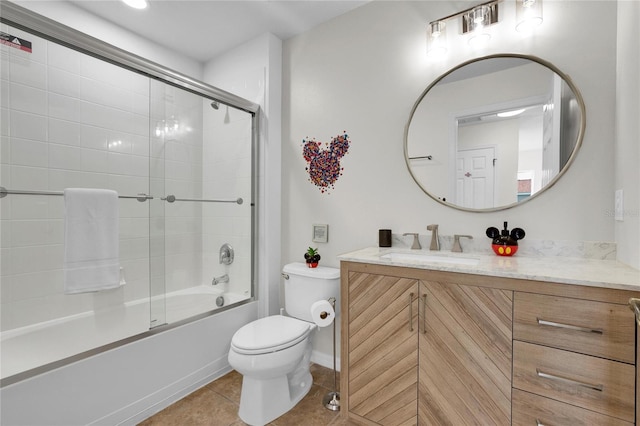 full bathroom with shower / bath combination with glass door, tile patterned floors, vanity, and toilet