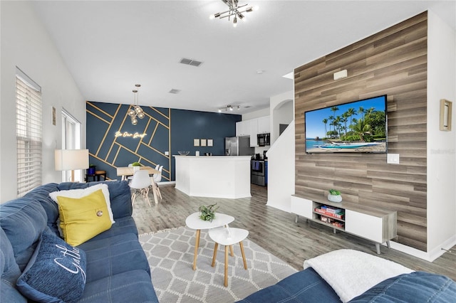 living room with wooden walls and hardwood / wood-style floors