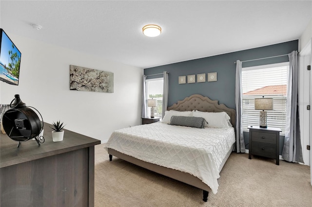 carpeted bedroom with multiple windows