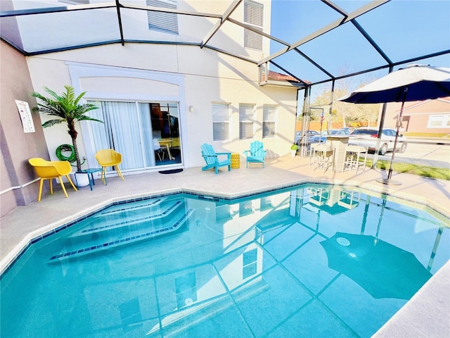 view of swimming pool featuring a patio area and glass enclosure