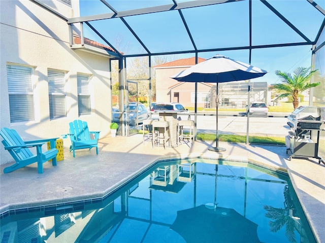 view of swimming pool with a lanai, area for grilling, and a patio area