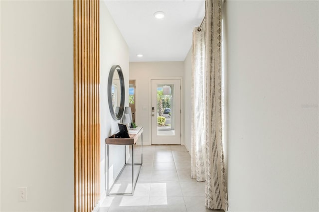 hall featuring light tile patterned floors