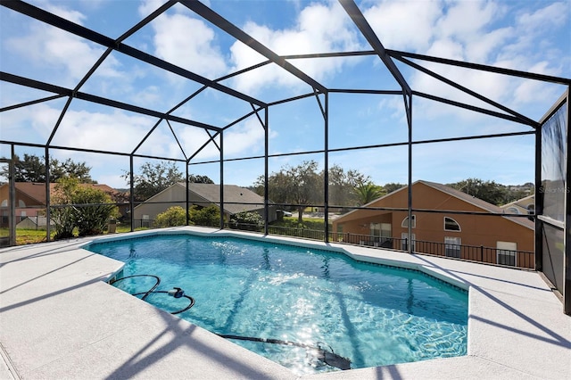 view of swimming pool featuring a patio area and glass enclosure