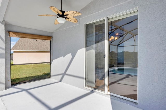 unfurnished sunroom featuring ceiling fan, vaulted ceiling, and a swimming pool