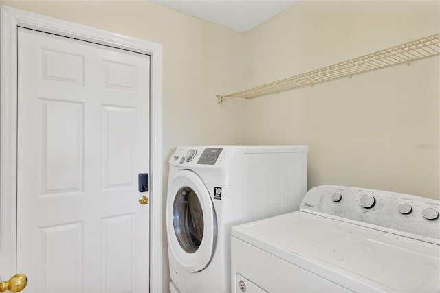 washroom with washing machine and clothes dryer