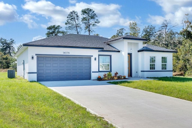 view of front facade with a front lawn, central AC unit, and a garage