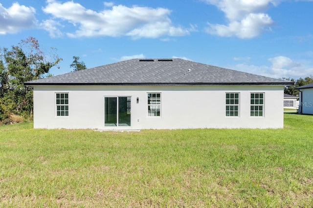 rear view of property with a yard