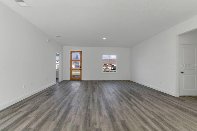 spare room featuring dark wood-type flooring