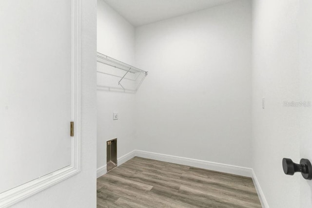 laundry room featuring hardwood / wood-style floors and electric dryer hookup