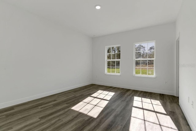 spare room featuring dark hardwood / wood-style flooring