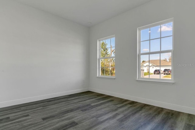 unfurnished room featuring dark wood-type flooring