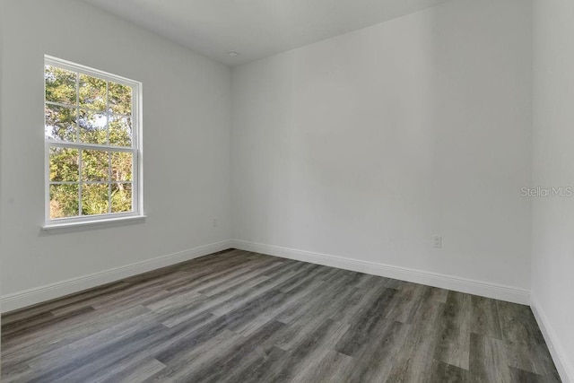 spare room with dark hardwood / wood-style flooring