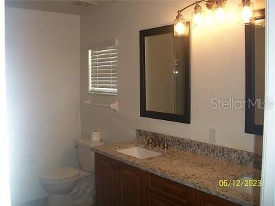 bathroom with toilet and vanity