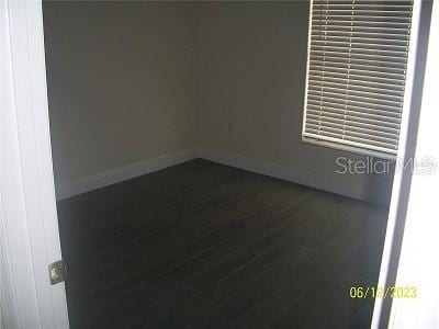 unfurnished room featuring dark hardwood / wood-style flooring