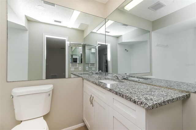 bathroom with visible vents, toilet, and vanity