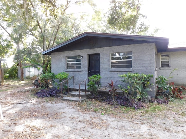 view of front of house featuring a storage shed