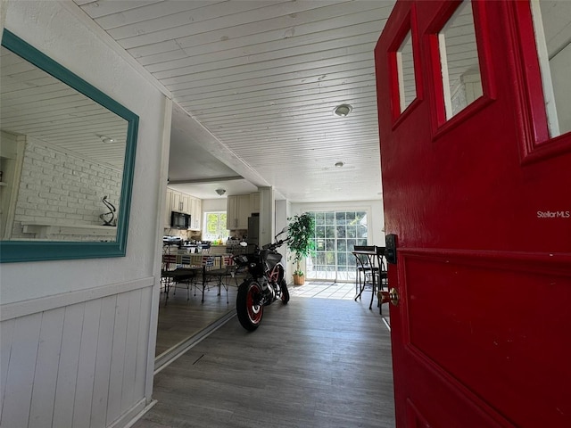 corridor featuring wooden walls and dark hardwood / wood-style floors