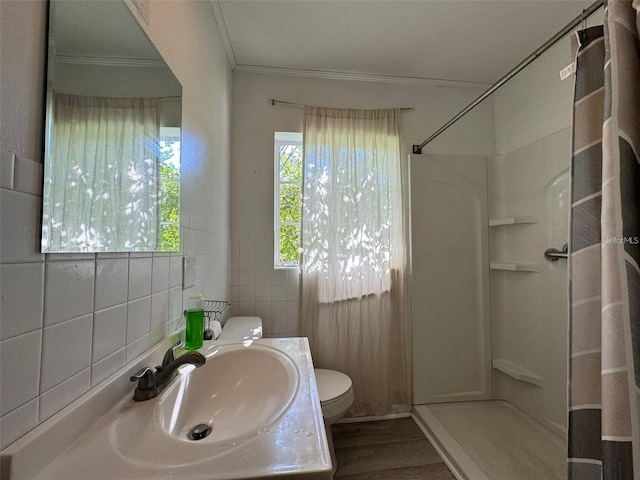 bathroom featuring toilet, tile walls, sink, and curtained shower